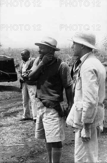 Pro-government Kikuyu and District Officer. District officer with a Kikuyu Home Guard sergeant. Kenya, circa 1953. Kenya, Eastern Africa, Africa.