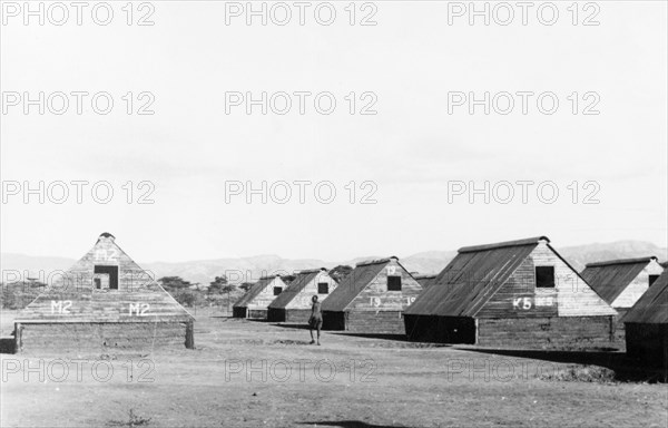 Home Guard living quarters. Numbered prefabricated huts form temporary accommodation for Kikuyu Home Guards. Kenya, circa 1953. Kenya, Eastern Africa, Africa.
