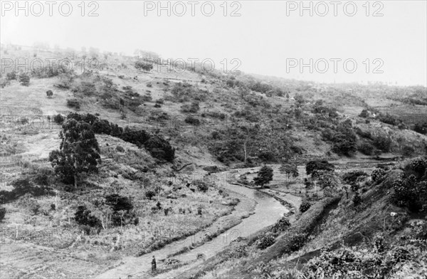 Typical Mau Mau country. View of a typical valley located in the highlands surrounding Mount Kenya. Forested with dense scrubland, this terrain afforded Mau Mau fighters the cover they needed to elude the opposition and plan their attacks. Central Kenya, circa 1955., Central (Kenya), Kenya, Eastern Africa, Africa.