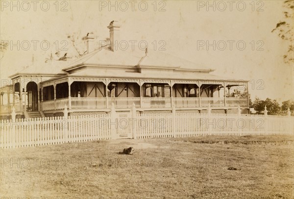House called 'Nundora', Toowoomba. The Brodribb family's house 'Nundora', surrounded by a white picket fence. The house is colonial in style with a veranda running around three of its sides and a gabled roof supported by pillars. Toowoomba, Australia, circa 1890. Toowoomba, Queensland, Australia, Australia, Oceania.