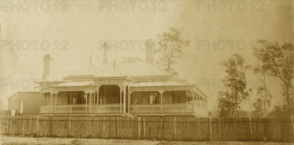 House called 'Nundora', Toowoomba. The Brodribb family's house 'Nundora', surrounded by a white picket fence. The house is colonial in style with a veranda running around three of its sides and a gabled roof supported by pillars. Toowoomba, Australia, circa 1890. Toowoomba, Queensland, Australia, Australia, Oceania.