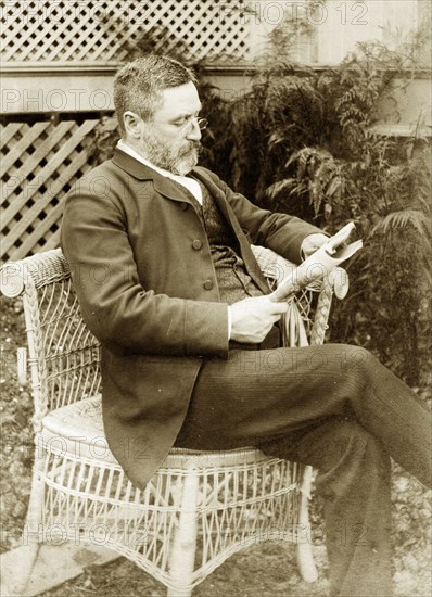 Dr Taylor relaxes at 'Nundora'. Portrait of a well-dressed gentleman identified as 'Dr Taylor' relaxing with a newspaper in the garden of 'Nundora', the Brodribb family's house. Toowoomba, Australia, circa 1895. Toowoomba, Queensland, Australia, Australia, Oceania.