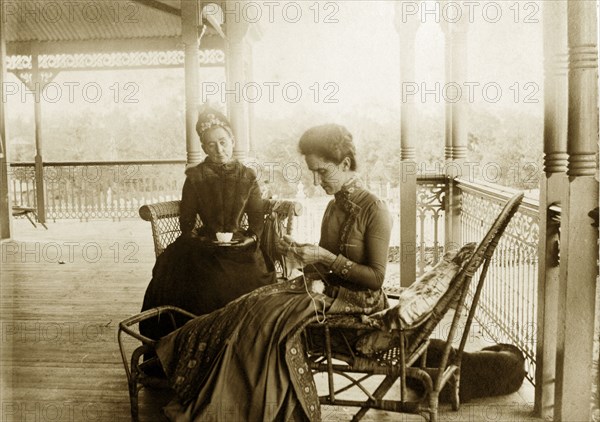 Knitting on the veranda at 'Nundora'. Informal portrait of 'Mrs Brown and Polly' taking tea and knitting on the veranda at the Brodribb's family house 'Nundora'. Toowoomba, Australia, circa 1895. Toowoomba, Queensland, Australia, Australia, Oceania.