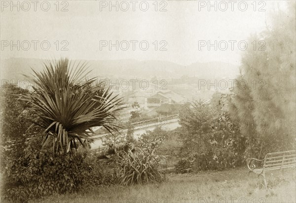View from Wickham Terrace. A garden bench faces out over the city of Brisbane in the sloping gardens belonging to a house at Wickham Terrace. Brisbane, Australia, circa 1890. Brisbane, Queensland, Australia, Australia, Oceania.