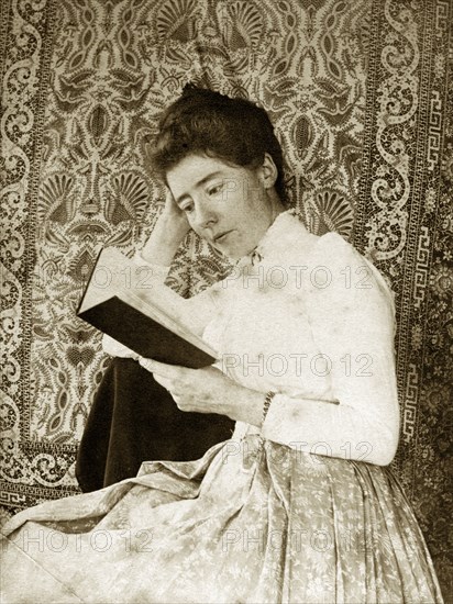 Portrait of a Victorian lady, Australia. Portrait of a Victorian lady reading from a book against a backdrop of patterned cloth. Queensland, Australia, circa 1895., Queensland, Australia, Australia, Oceania.