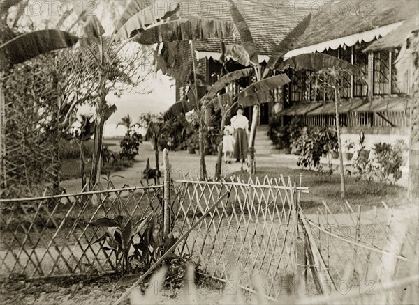 Bungalow garden on the Andaman Islands. A woman and child identified as 'Marjory and Mother' wander through cultivated gardens beside a Port Officer's bungalow. Port Blair, Andaman Islands, India, 1909. Port Blair, Andaman and Nicobar Islands, India, Southern Asia, Asia.