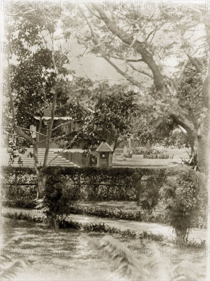 Port Officer's bungalow. A view across well-kept gardens looking towards a Port Officer's bungalow with guard house opposite. Port Blair, Andaman Islands, India, circa 1909. Port Blair, Andaman and Nicobar Islands, India, Southern Asia, Asia.