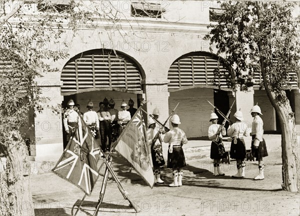 Relieving sentries. Uniformed sentries from a Scottish regiment cross their bayonets as they perform a change of guard. Rawalpindi, Punjab, India (Punjab, Pakistan), circa 1895. Rawalpindi, Punjab, Pakistan, Southern Asia, Asia.