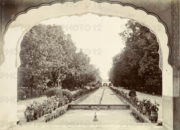 Shalimar Gardens, Lahore. View through a decorative archway of the formal Shalimar Gardens at Lahore. Long lines of trees and potted plants flank the edges of a shallow, dry canal fitted with fountain heads. Lahore, Punjab, India (Punjab, Pakistan), circa 1895. Lahore, Punjab, Pakistan, Southern Asia, Asia.