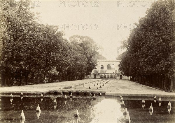 Fountains in the Shalimar Gardens. Long lines of trees surround a series of shallow canals fitted with fountain heads at the formal Shalimar Gardens. Lahore, Punjab, India (Punjab, Pakistan), circa 1895. Lahore, Punjab, Pakistan, Southern Asia, Asia.