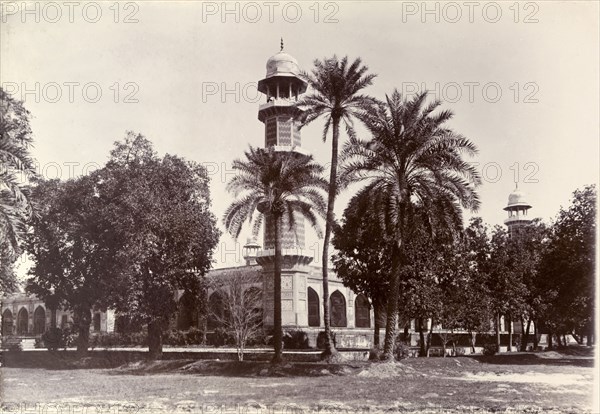Shahdara Gardens, Lahore. One of several decorative minarets peeps above the treeline at the formal Shahdara Gardens. Lahore, Punjab, India (Punjab, Pakistan), circa 1895. Pakistan, Southern Asia, Asia.