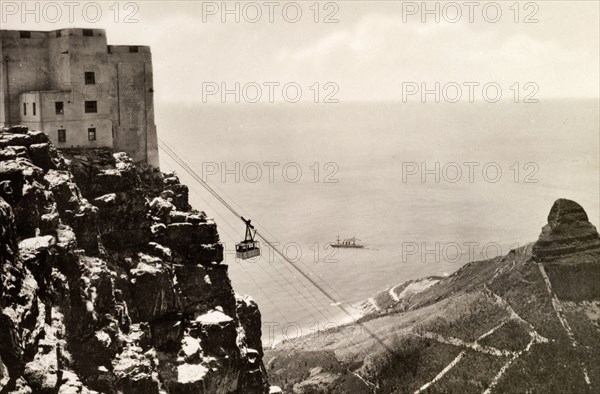 Cablecar at Table Mountain. A cablecar en route at Table Mountain. The famous Lion's Head mountain overlooks Cape Town to the right. Cape Town, Cape Province (West Cape), South Africa, circa 1936. Cape Town, West Cape, South Africa, Southern Africa, Africa.