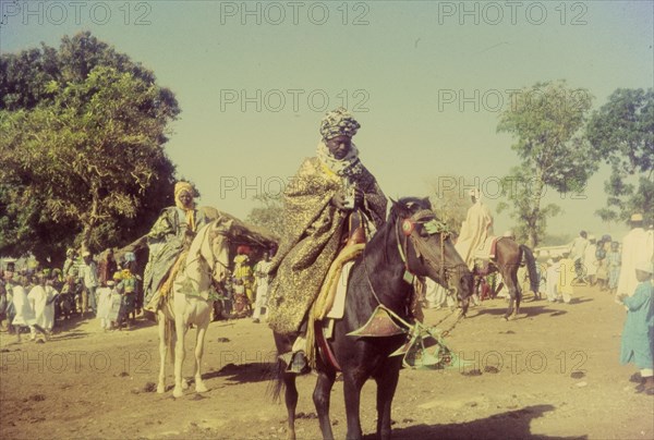 Celebrating the end of Ramadan. Men in traditional dress on horseback at a celebration marking the end of Ramadan. Zaria, Nigeria, 1958. Zaria, Kaduna, Nigeria, Western Africa, Africa.