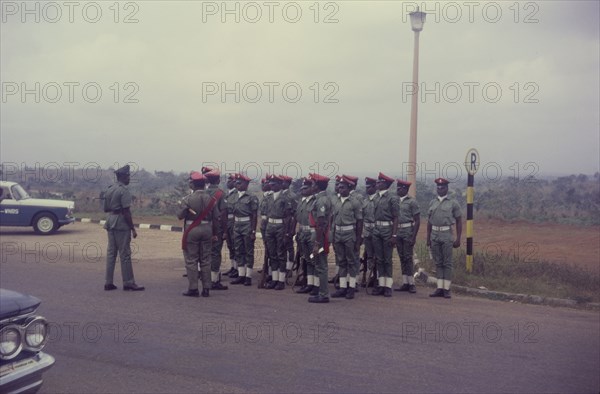 Nigerian military police. Uniformed military police, pictured towards the end of the Nigerian Civil War (1967-70), stand to attention at a roadside stop. Nigeria, circa January 1970. Nigeria, Western Africa, Africa.