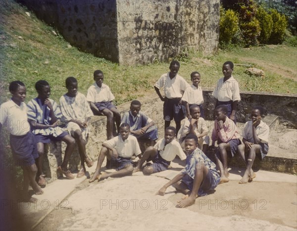 Church of Nigeria schoolboys. Uniformed boys from a Church of Nigeria school relax outdoors on a sunny day. Nigeria, circa 1964. Nigeria, Western Africa, Africa.