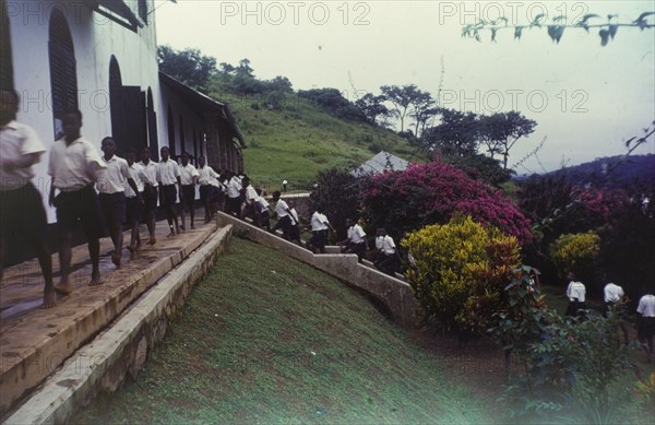 Church of Nigeria schoolboys. Uniformed boys file up steps and across a terrace on their way to lessons at a Church of Nigeria school. Nigeria, circa 1964. Nigeria, Western Africa, Africa.