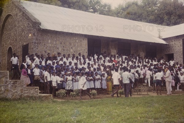 Student union rally. Uniformed students line up for a student union rally outside a Church of Nigeria college building. Nigeria, circa 1964. Nigeria, Western Africa, Africa.