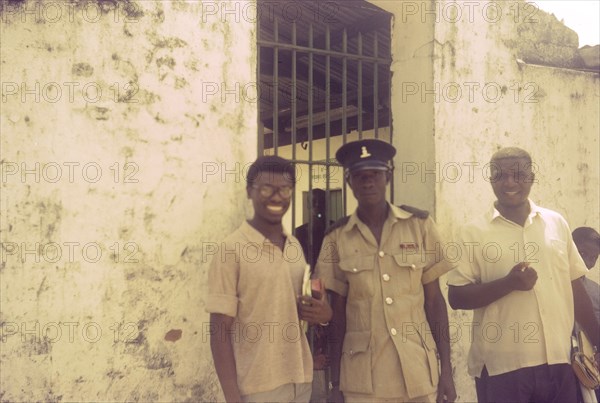 A priest visits Badagry prison. A Church of Nigeria priest, identified as Sonkor Adigili, makes a visit to Badagry prison, his bible clutched in his hand. Badagry, Nigeria, circa 1970. Badagry, Lagos, Nigeria, Western Africa, Africa.
