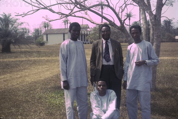Canon Falofe with catechists. Outdoors portrait of Canon Falofe, a Church of Nigeria priest, with three training catechists. Nigeria, circa 1968. Nigeria, Western Africa, Africa.