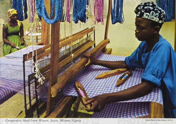 Hand loom weaver, Nigeria. A colourful tourist postcard depicts a hand loom weaver at work in a Nigerian co-operative. Western Nigeria, circa 1975. Nigeria, Western Africa, Africa.
