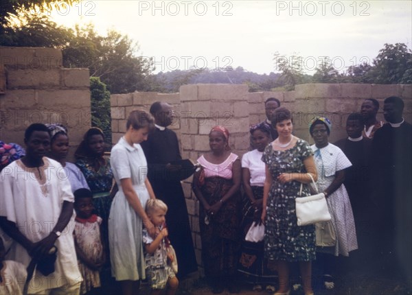 An Archdeacon blesses a new ward. An Archdeacon reads from the bible as he blesses the construction of a new ward at a Church of Nigeria hospital. Nigeria, November 1963. Nigeria, Western Africa, Africa.