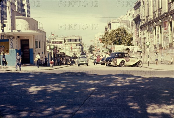 Granville Road, Kowloon. People and cars mill about on Granville Road in the afternoon sunshine. Kowloon, Hong Kong, People's Republic of China, July 1960. Kowloon, Hong Kong, China, People's Republic of, Eastern Asia, Asia.