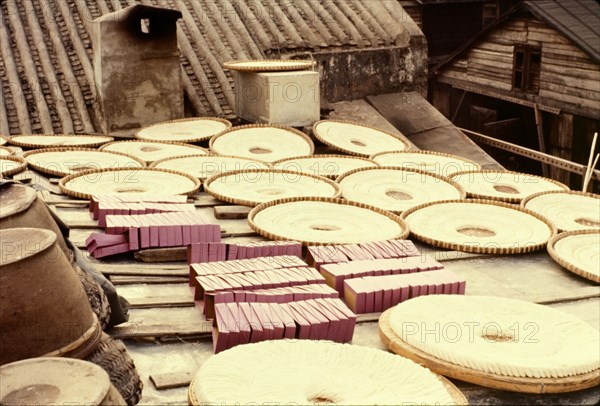 Noodles drying in the sun. Rings of noodles laid out to dry in the sun in flat baskets on a rooftop. Aberdeen, Hong Kong, People's Republic of China, January 1961. Aberdeen, Hong Kong, China, People's Republic of, Eastern Asia, Asia.