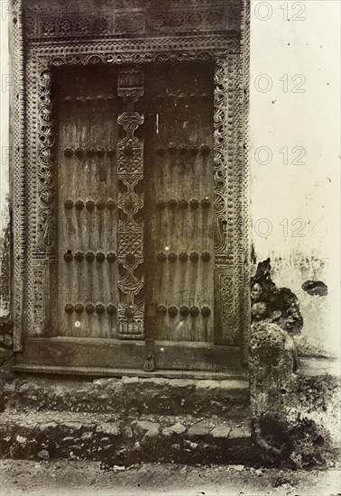 Ornate doorway, Zanzibar. An ornately carved wooden door in Zanzibar. Zanzibar (Tanzania), 1906. Zanzibar Town, Zanzibar Urban/West, Tanzania, Eastern Africa, Africa.