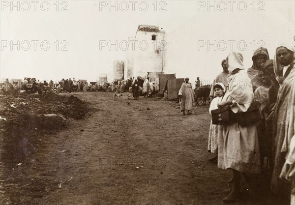 City walls of Casablanca. Crowds line a dirt track running past the city walls. Casablanca, Morocco, 1898. Casablanca, Casablanca, Morocco, Northern Africa, Africa.