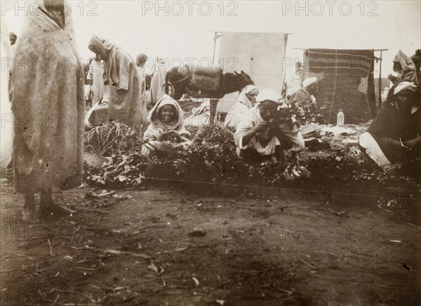 Market scene, Casablanca. Street traders crouch on the ground, trying to sell fruit and vegetables at a local market. Casablanca, Morocco, 1898. Casablanca, Casablanca, Morocco, Northern Africa, Africa.