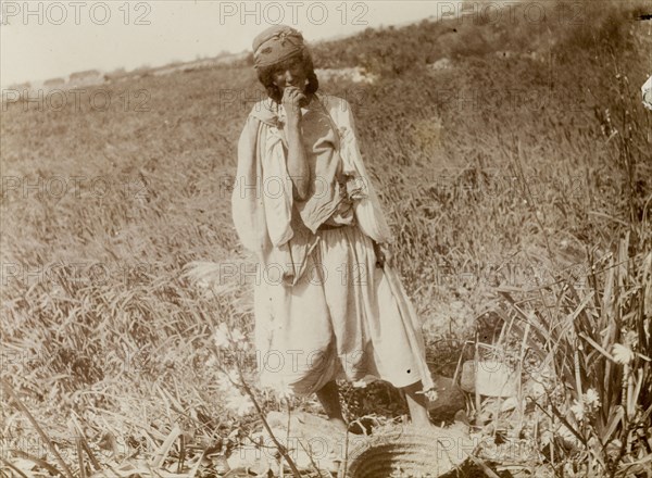 Woman fieldworker, Morocco. Outdoors portrait of a young woman in a field with a basket. Morocco, 1898. Morocco, Northern Africa, Africa.
