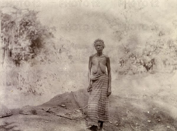 Woman rural labourer, Morocco. Outdoors portrait of a thin, elderly woman. She wears a long cloth around her waist, but is naked from the waist up. Morocco, 1898. Morocco, Northern Africa, Africa.