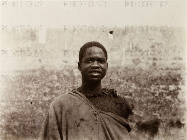 Labourer in Safi, Morocco. Outdoors portrait of a sub-Saharan African man in ragged clothing. A caption identifies him as a 'worker'. Safi, Morocco, 1898. Safi, Safi, Morocco, Northern Africa, Africa.