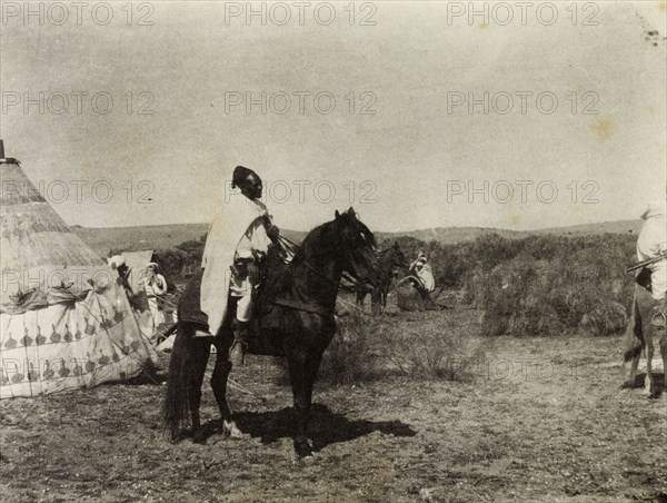 Frederick Stanbury's escort in Morocco. An African escort mounted on horseback waits to depart from a temporary camp site erected for Frederick Stanbury and his travelling party. Southern Morocco, 1898. Morocco, Northern Africa, Africa.