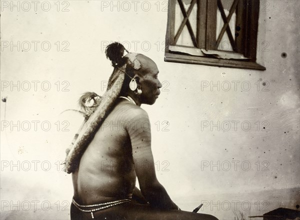 Turkana man's hairstyle. Profile shot showing the hairstyle of a Turkana man, daubed in traditional Turkana style using blueish clay. British East Africa (Kenya), 1906. Kenya, Eastern Africa, Africa.