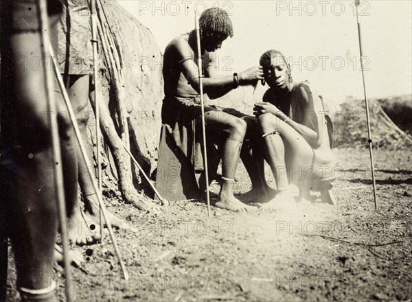 Maasai hairdressing. Maasai society is ordered by age groups and the young men shown here probably belong to the age group of junior or unmarried warriors (moran). Usually on passing from junior to senior warrior status the men have their heads shaved. British East Africa (Kenya), 1906. Kenya, Eastern Africa, Africa.
