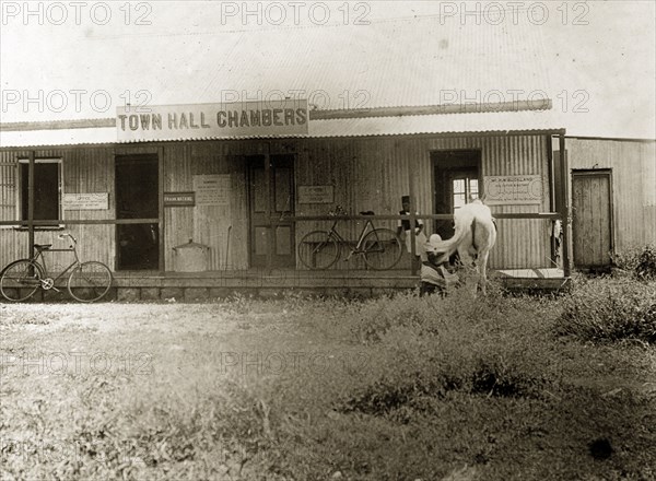 Town Hall Chambers, Nairobi. Bicycles and a horse stand outside the The Town Hall Chambers in Nairobi, a low-level building constructed from corrugated metal. Nairobi, British East Africa (Kenya), 1906. Nairobi, Nairobi Area, Kenya, Eastern Africa, Africa.