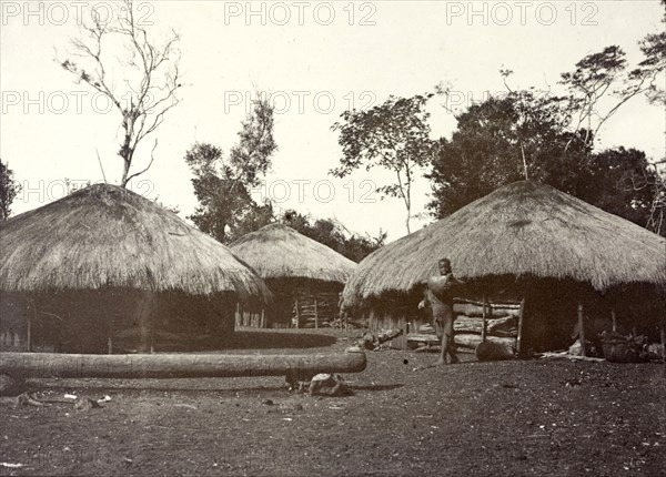 Thatched village huts, Kikuyu. Several round huts with thatched roofs are built closely together in a village. Kikuyu, British East Africa (Kenya), 1906. Kenya, Eastern Africa, Africa.