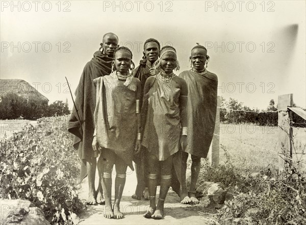 Young Kikuyu men and women. Informal group portrait of two young Kikuyu women and three men. British East Africa (Kenya), 1906. Kenya, Eastern Africa, Africa.