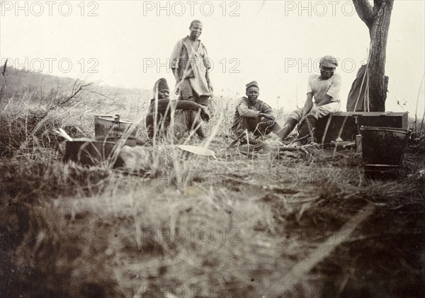 Safari camp 'kitchen'. African cooks and servants pictured outdoors in a makeshift 'kitchen' at Frederick Stanbury's safari camp. British East Africa (Kenya), 1906. Kenya, Eastern Africa, Africa.
