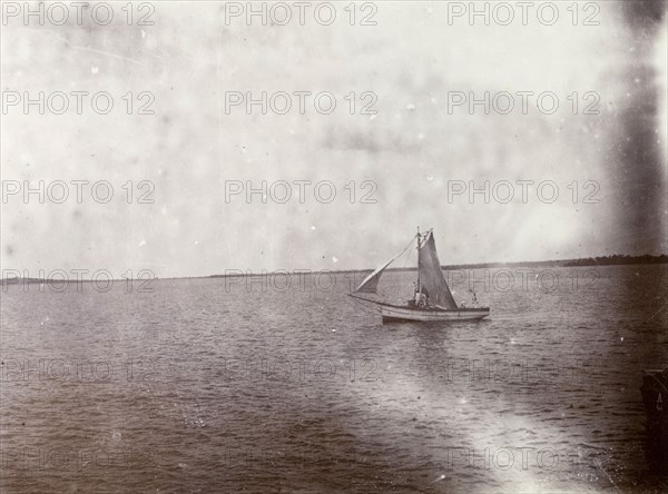Mail boat on Lake Victoria. A small mail boat sails of the coast of Lake Victoria. Lake Victoria, British East Africa (Kenya), 1906., Nyanza, Kenya, Eastern Africa, Africa.