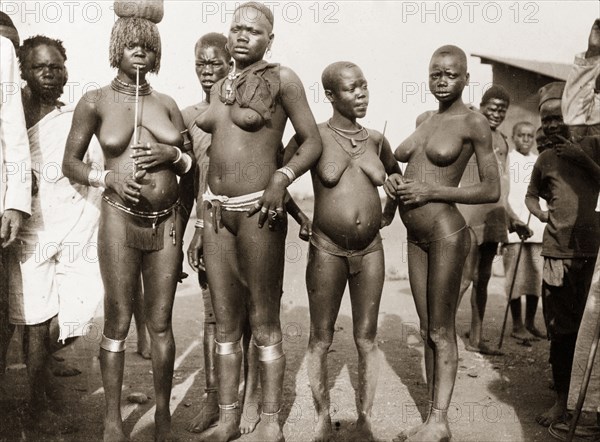 Luo women at Kisumu. Portrait of four nearly naked Luo women at a local market. Kisumu, British East Africa (Kenya), 1906. Kenya, Eastern Africa, Africa.