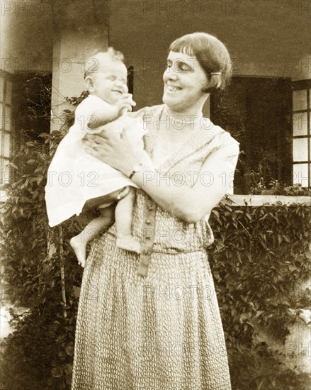 Charles Trotter as a baby. Margaret Trotter is delighted by her baby Charles as she holds him proudly on her arm. Uganda, circa April 1924. Uganda, Eastern Africa, Africa.