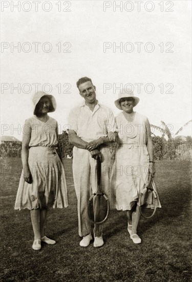 Margaret Trotter at Lagos. Margaret Trotter (right) poses for the camera with friends. The group wear sporting whites and hold tennis racquets. Lagos, Nigeria, April 1932. Lagos, Lagos, Nigeria, Western Africa, Africa.