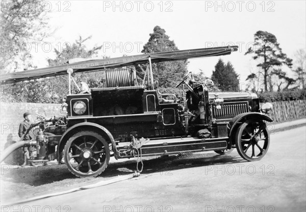 Lymington Fire Brigade. A stencilled sign on the ladder of this open-topped fire engine identifies it as a vehicle belonging to 'Lymington Fire Brigade'. Lymington, England, circa 1935. Lymington, Hampshire, England (United Kingdom), Western Europe, Europe .