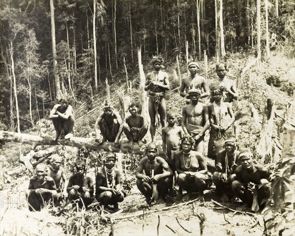 North Malaysian aborigines. Portrait of a group of Malaysian aborigines sitting amongst the forest undergrowth. Semi-naked, their bodies are decorated with jewellery and wreaths of leaves that adorn their heads. Gerik, British Malaya (Malaysia), 1900. Gerik, Perak, Malaysia, South East Asia, Asia.