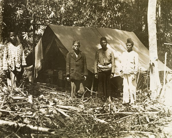 Malay surveying assistants. Malay assistants outside a camp on a British-led trigonometrical survey. Probably in northern Perak, British Malaya (Malaysia), circa 1901., Perak, Malaysia, South East Asia, Asia.