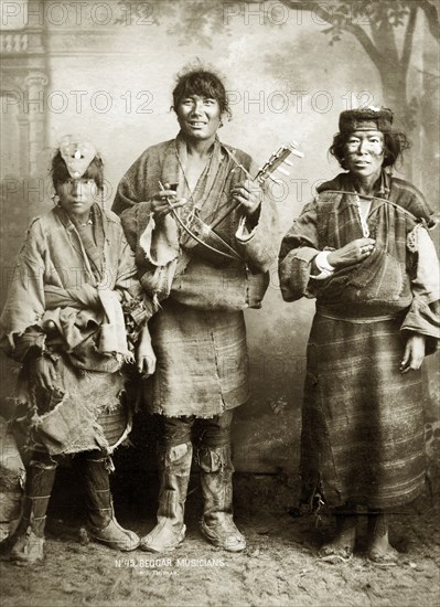 Beggar musicians, India. Studio portrait of three itinerant female musicians, probably of Tibetan origin, photographed at or near Darjeeling. West Bengal, India, circa 1900., West Bengal, India, Southern Asia, Asia.