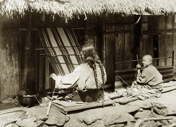 Two weavers, India. Two weavers, a woman and a child, at work on outdoor looms near Darjeeling. West Bengal, India, circa 1900., West Bengal, India, Southern Asia, Asia.