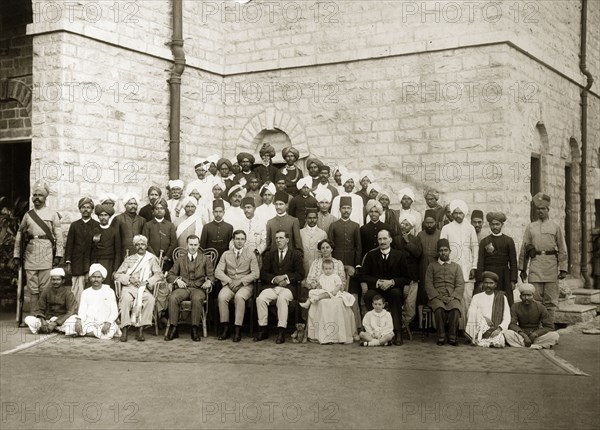 Bank of Bengal staff. Group portrait of European and Indian office staff, peons and guards, probably of a branch of the Bank of Bengal. India, circa 1905. India, Southern Asia, Asia.